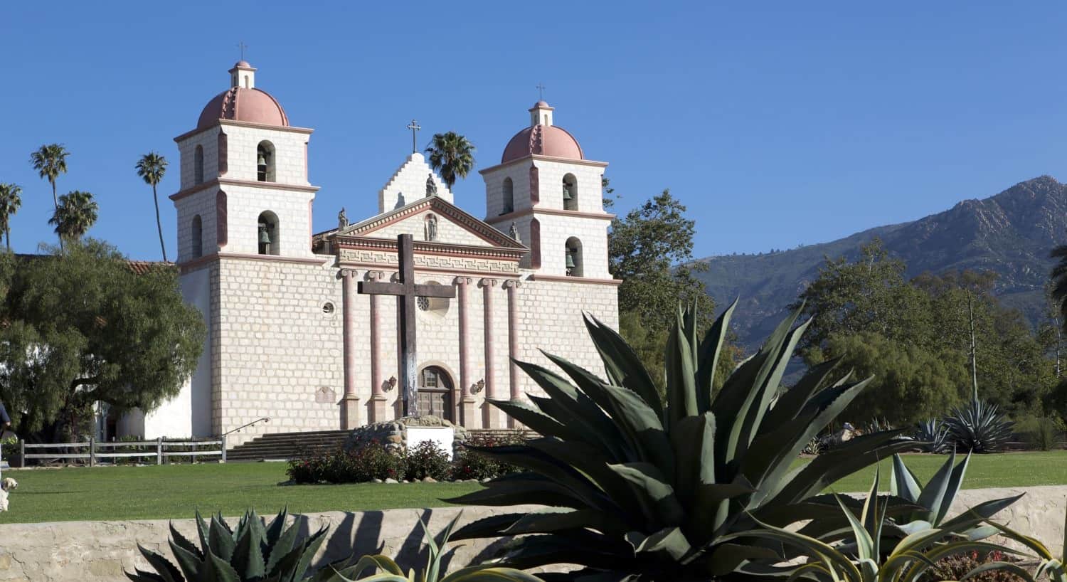 Spanish style building with two flanking towers, ivory stucco, red tiled roof