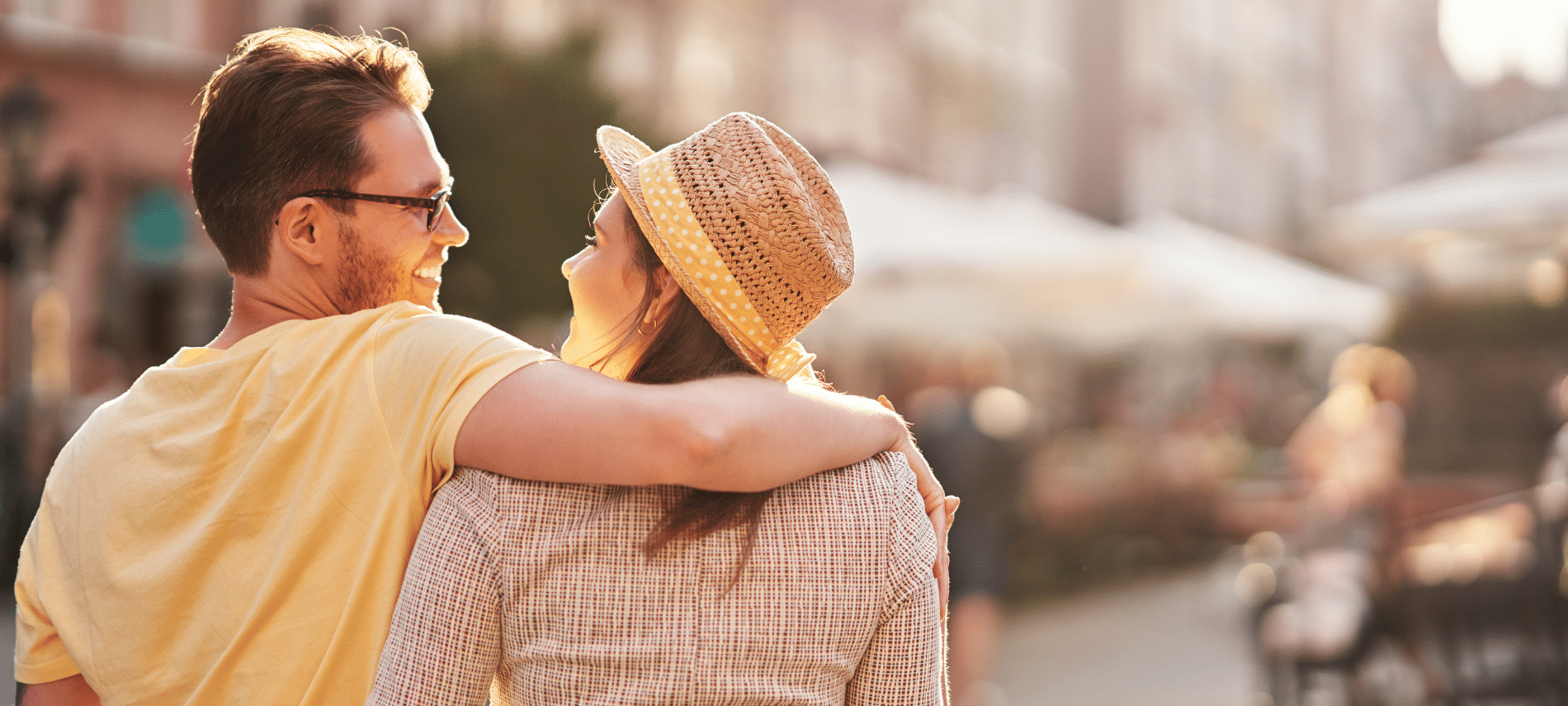 couple walking arm in arm outdoors enjoying a sunny vacation moment together