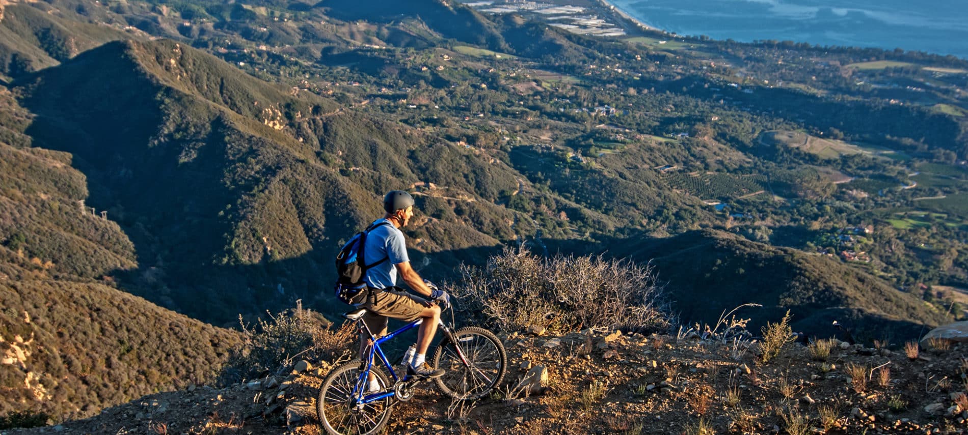 Cyclist in the mountains overlooking the Pacific coast of Santa Barbara CA