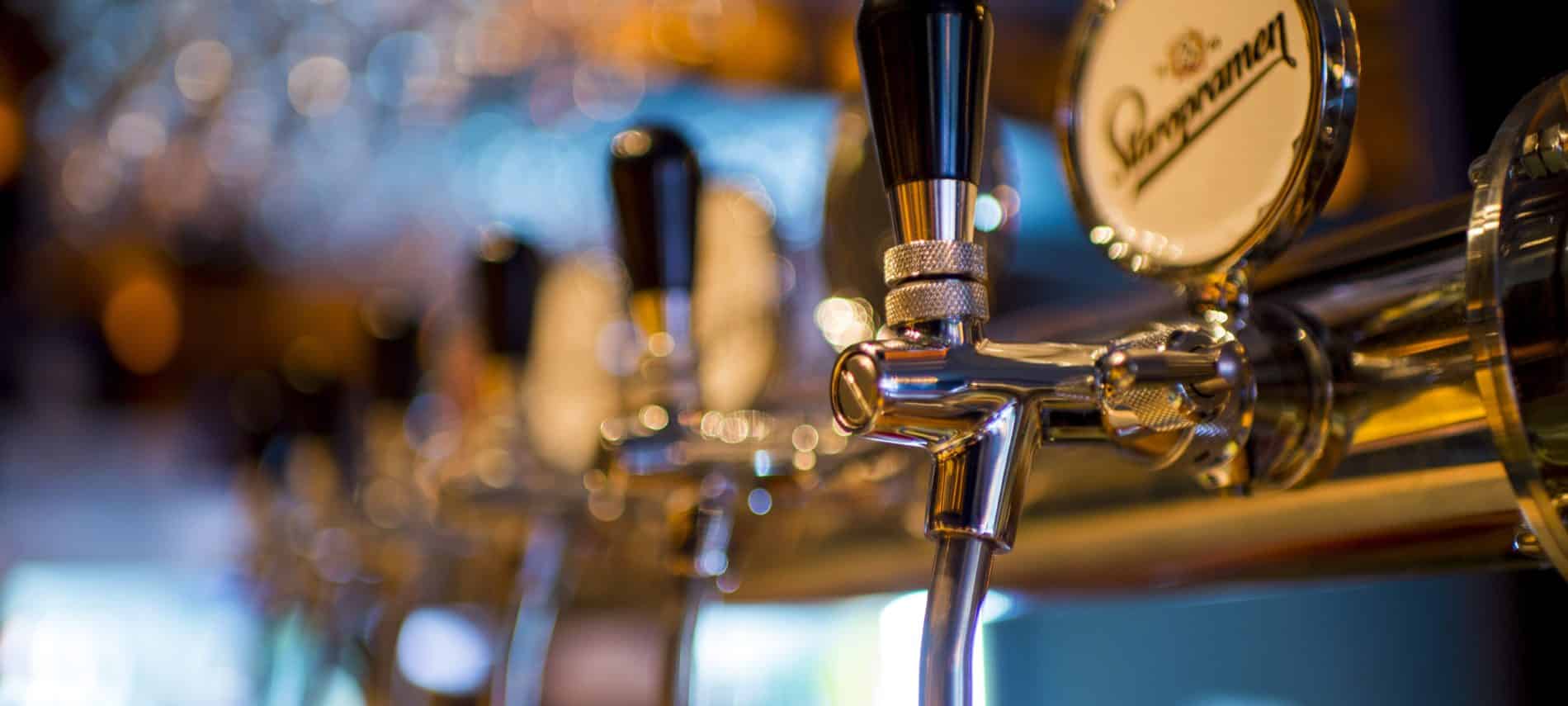 Row of stainless steel beer taps