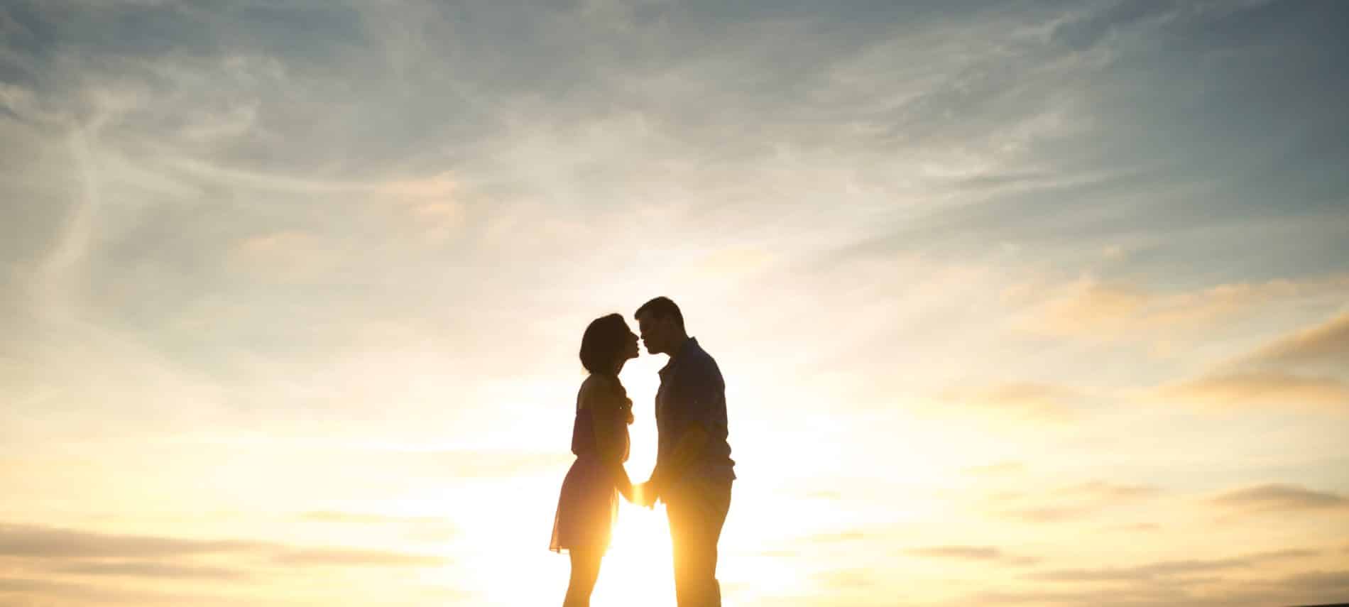 silhouette of man and woman about to kiss