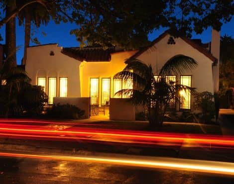 Casitas at dusk with lights on and silhouette of trees overhead