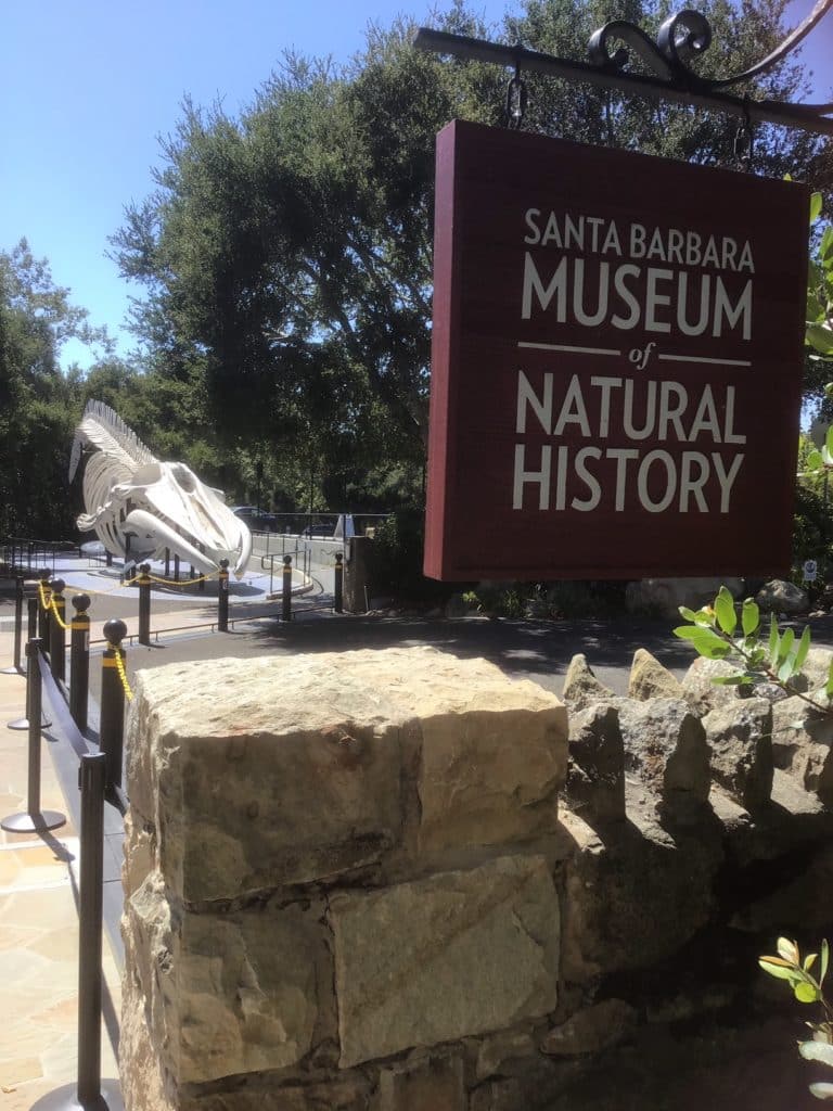 Brown wooden sign outside that says Santa Barbara Museum of Natural History