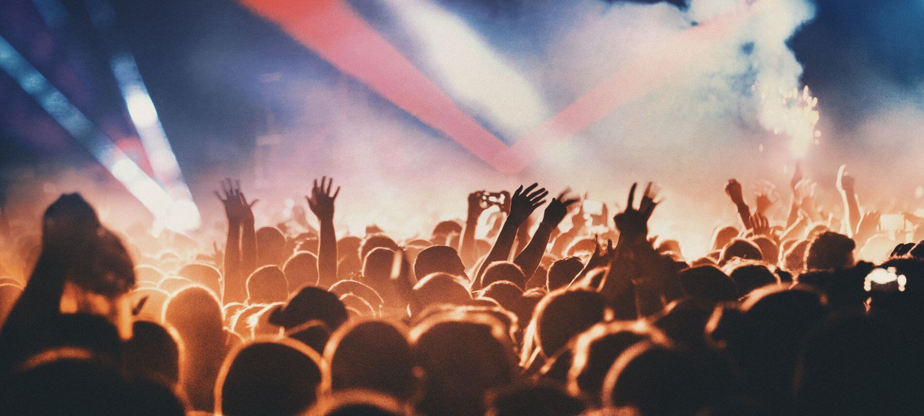 a crowd of people outside enjoying a concert