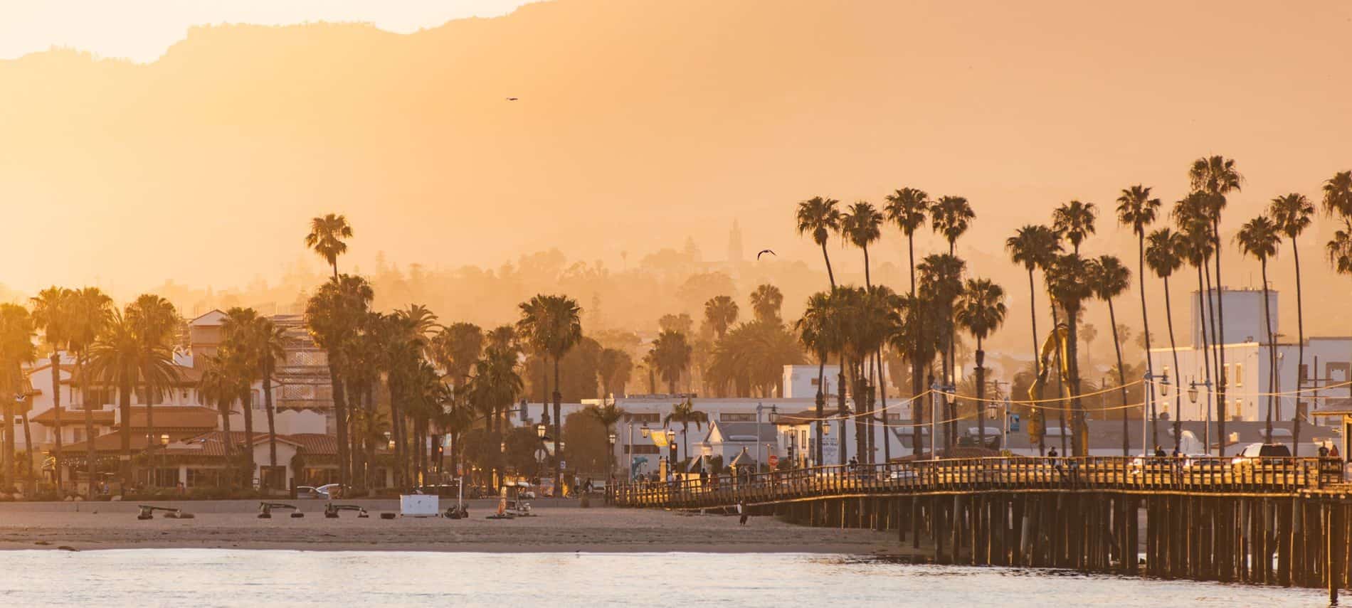 Santa Barbara pier by the beach with silhouette of mountains in the background