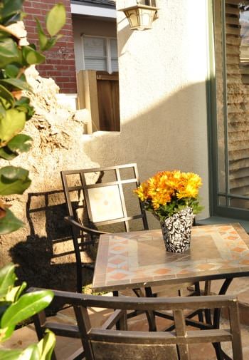 San Clemente guest patio with brown patio chairs and table