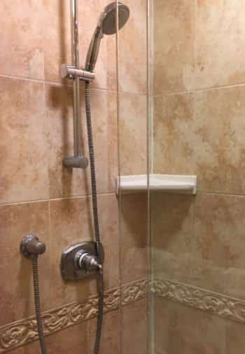 Double queen bathroom with tiled shower and glass sliding door